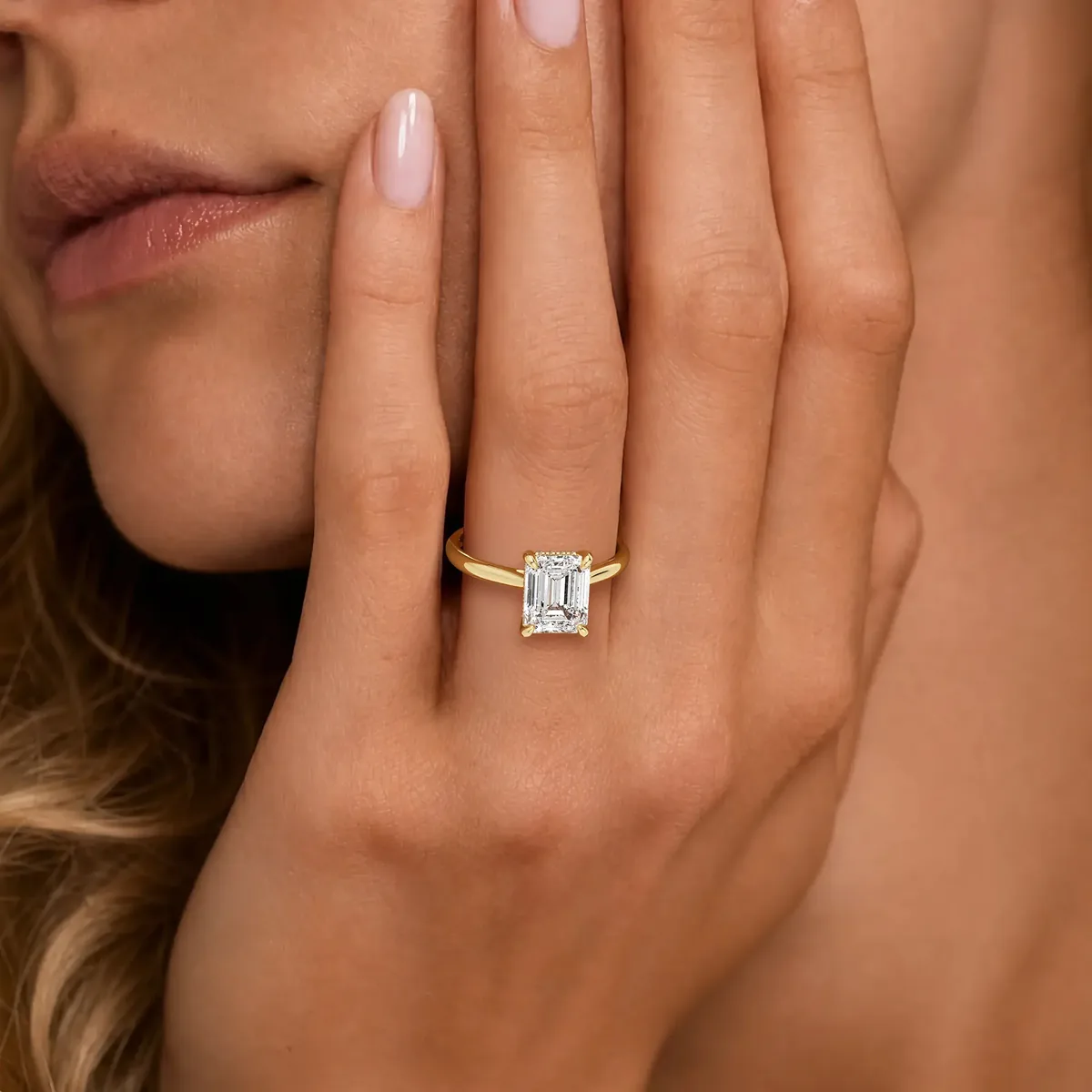 Anillo de compromiso solitario con diamante talla esmeralda en oro amarillo
